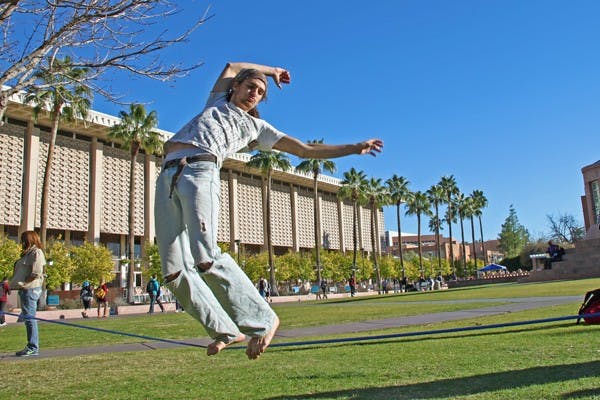 WALK THE LINE: Aerospace engineering senior Carlin Kersch spends some time slack-lining before returning to class. (Photo by Rosie Gochnour)