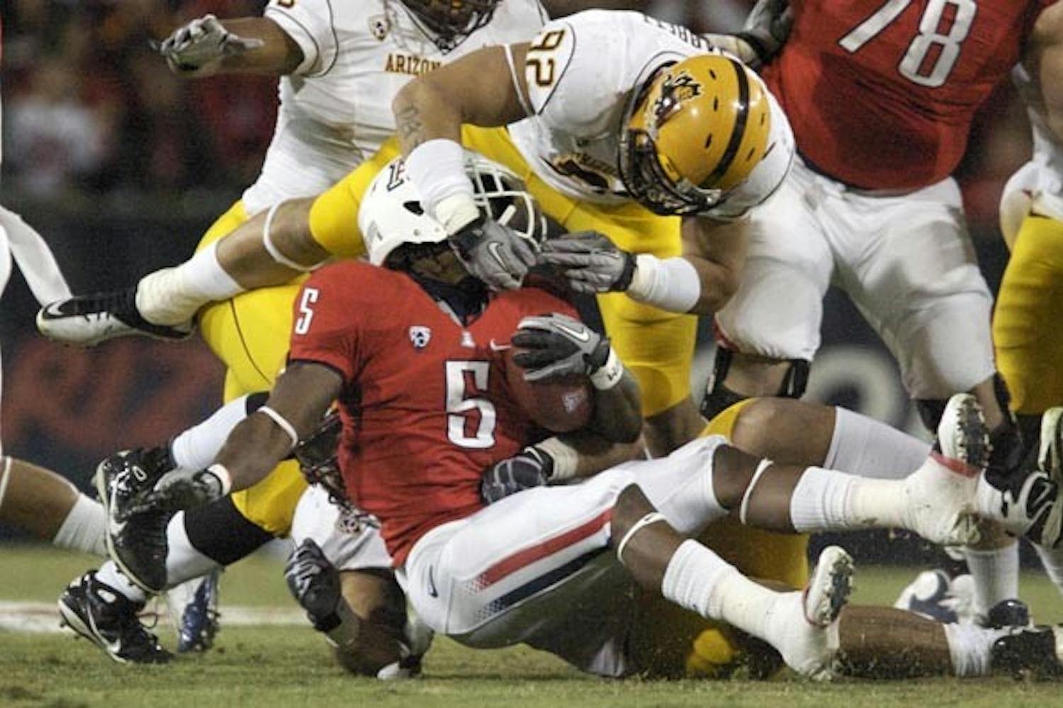 DOWN AND OUT: Junior defensive end Jamaar Jarrett tackles UA senior running back Nic Grigsby during last week's Territorial Cup game. The game, an ASU win, marked the end of ASU's 2010 season, one that the team hopes will be a stepping stone to a successful 2011 campaign. (Photo by Scott Stuk)