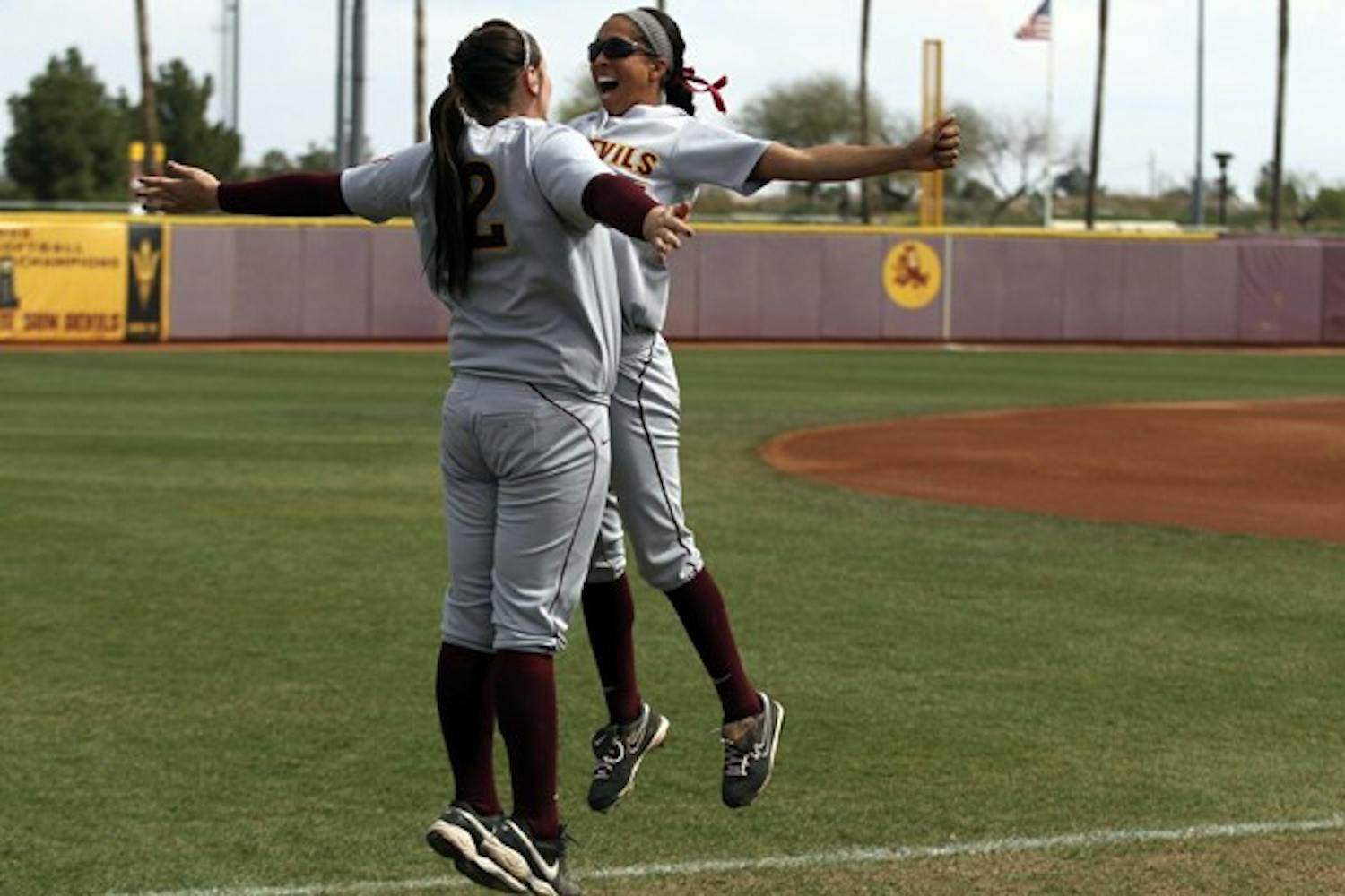 Alix Johnson and Dallas Escobedo celebrate at a game against New Mexico State on March 11. Johnson leads the Sun Devils with a .558 batting average. (Photo by Jenn Allen)