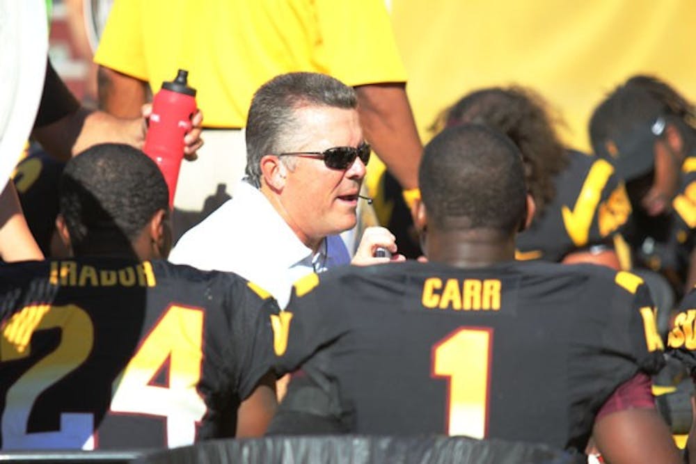 Redshirt junior cornerback Osahon Irabor and redshirt senior cornerback Deveron Carr listen to coach Todd Graham in a huddle during the Sun Devils’ 45-43 loss to UCLA on Oct. 27. (Photo by Kyle Newman)
