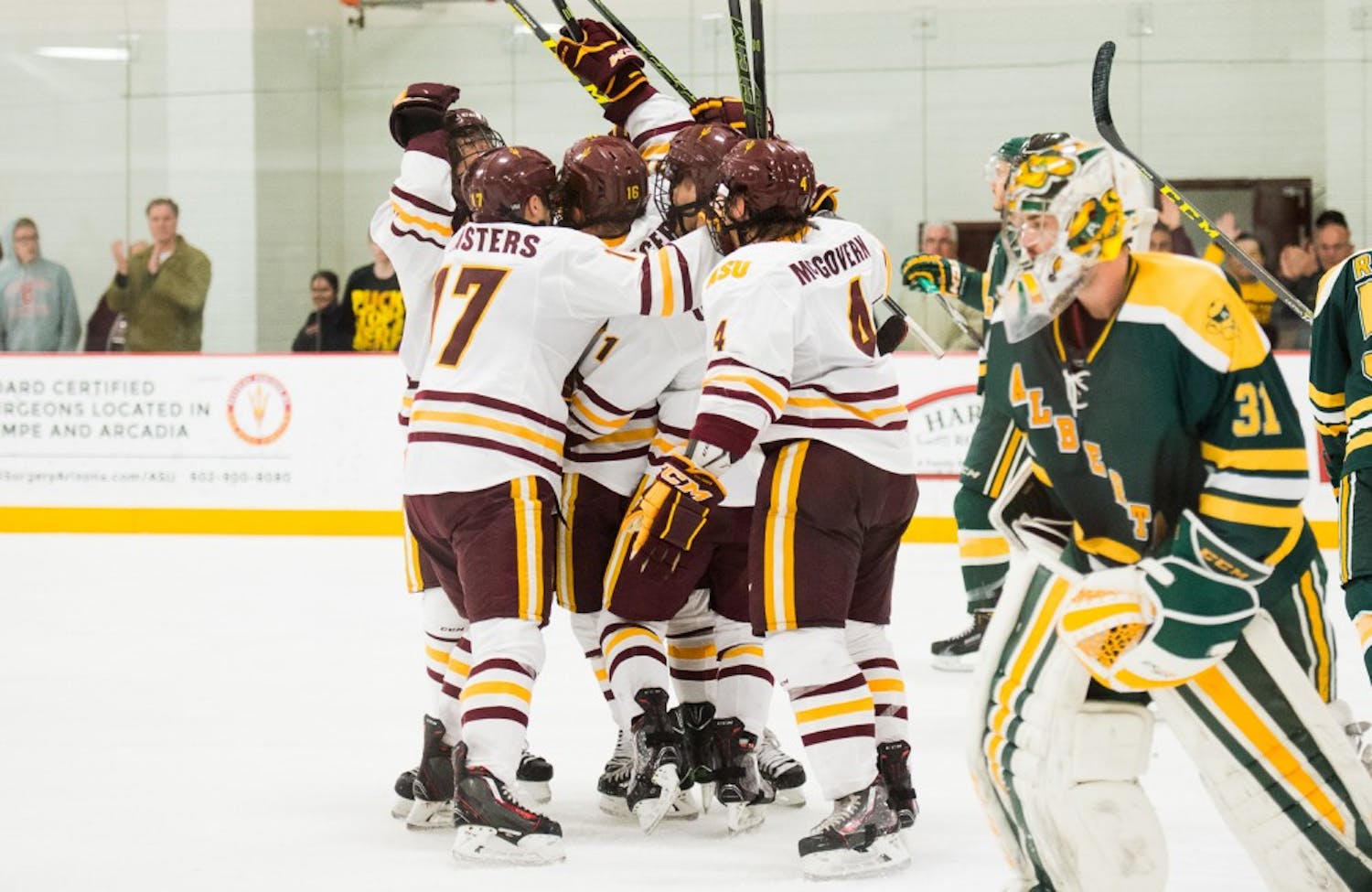 The ASU hockey team celebrates after a game-tying goal in overtime against the University of Alberta on Friday, Dec. 4, 2015, at Oceanside Ice Arena in Tempe. The Sun Devils defeated the Golden Bears 5-4 in a shootout.