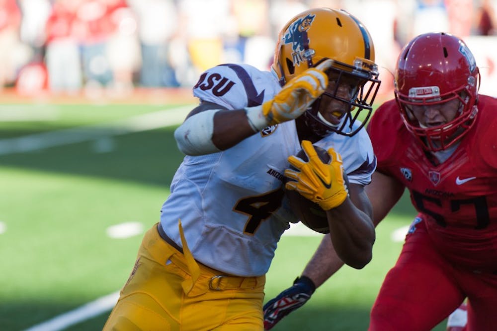 Freshman running back Demario Richard runs the ball in a game against the University of Arizona, Friday, Nov. 28, 2014 at Arizona Stadium in Tucson. ASU will have to focus on running the ball against Duke in the Hyundai Sun Bowl on Dec. 27. (Photo by Ben Moffat)