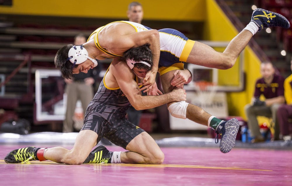 ASU's Robbie Mathers, bottom, lifts UNC's Sonny Espinoza off the mat in a 141-pound matchup during a meet against the University of Northern Colorado at Wells Fargo Arena in Tempe on Thursday, Nov. 12, 2015. The Sun Devils took down the UNC Bears 21-14.