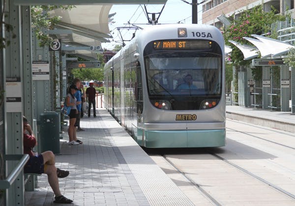 MAKING THE ROUNDS: The Metro Light Rail picks up passengers at the stop on Mill Avenue and Third Street in Tempe on August 21. (Photo by Ben Jackson)