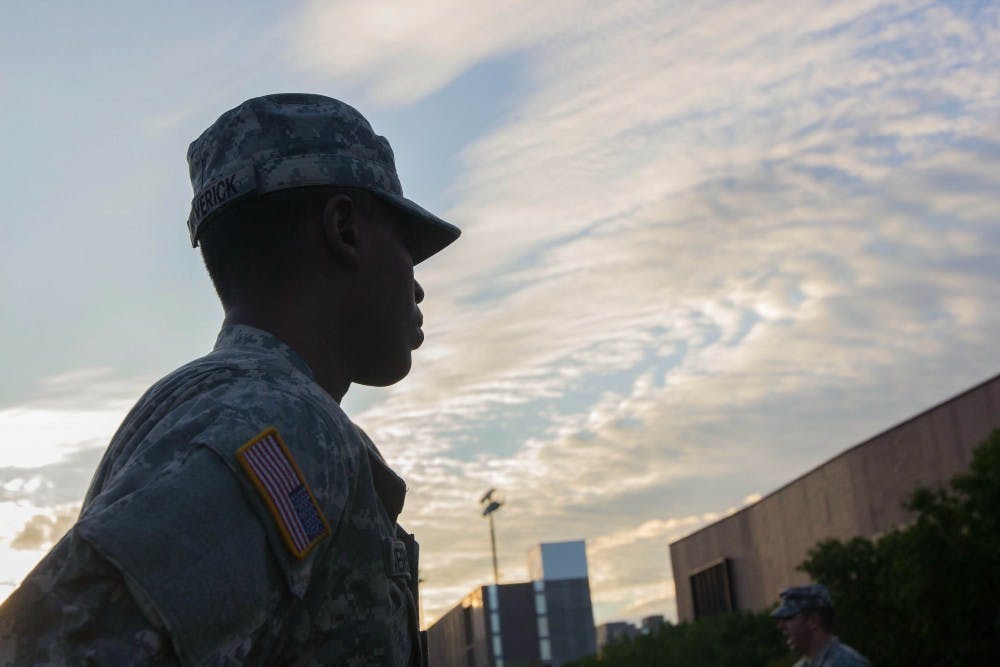 An ASU cadet looks on as he stands in formation before a marching exercise. ASU's lab practicals begin every Wednesday morning at the SRC fields on the Tempe campus (Photo by Dominic Valente) 