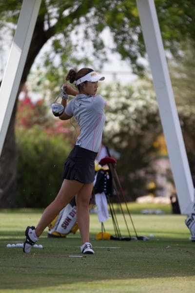 Senior Justine Lee swings at a practice on April 9. (Photo by Diana Lustig)