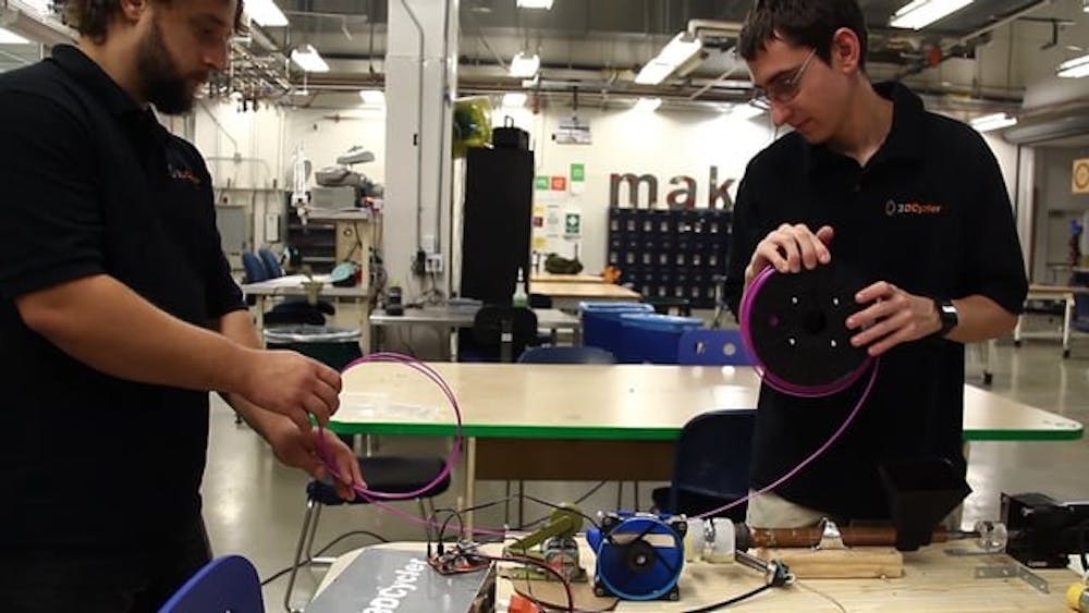 ASU engineering students Joshua Kosar and Riley Chicci pictured with the 3DCycler they created.