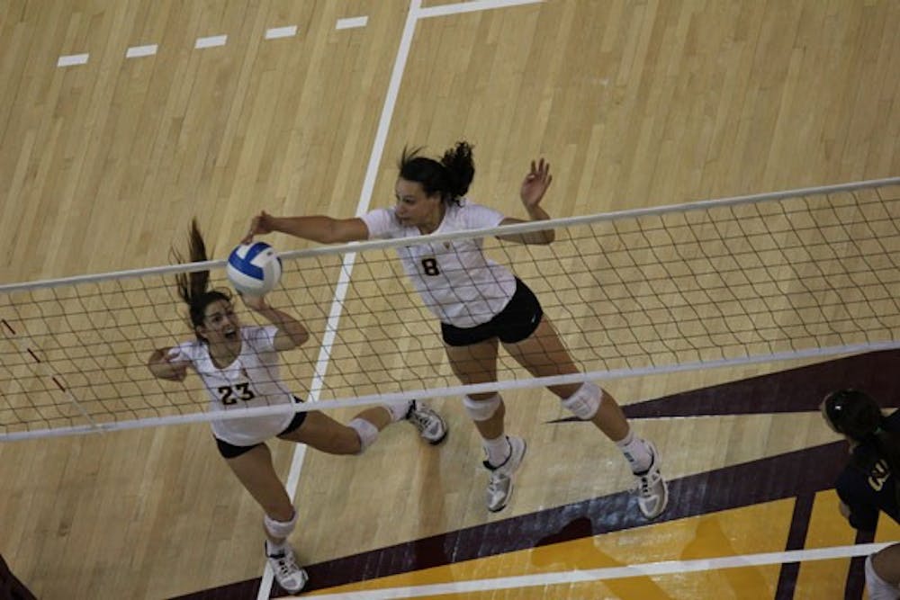 Freshman outside hitter Whitney Follette (8) hits the ball over the net as freshman setter Allison Palmer (23) watches during the Sun Devils’ 3-0 win over California on Sept. 28.