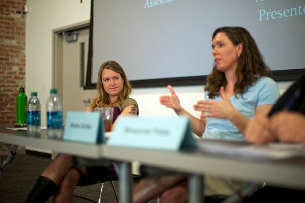 WOMAN AS HERO: Postgraduate ASU student and poet Amy Pearson listens to fellow panelist Alesha Durfee address the modern feminist movement during the Woman as Hero workshop on the Downtown campus, which focused on contemporary female issues. Durfee is an Assistant Professor of Women and Gender Studies at ASU. (Photo by Michael Arellano)