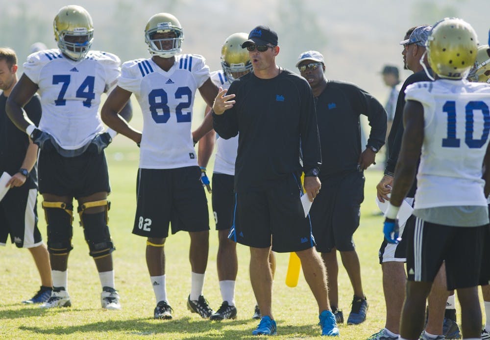 UCLA football head coach Jim Mora instructs members of his team Saturday morning. (Photo Courtesy of Katie Meyers/The Daily Bruin)