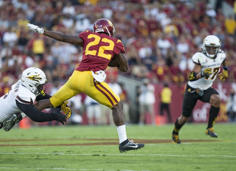 Trojan wide receiver Josh Imatorbhebhe (22) fights through Sun Devil defenders during a game against the USC Trojans in the Los Angeles Memorial Coliseum on Saturday, Oct. 1, 2016. 