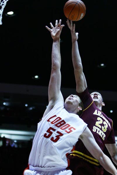 FALLING SHORT: ASU sophomore center Ruslan Pateev and New Mexico freshman center Alex Kirk battle for a rebound during Tuesday night's game in Albuquerque. The Lobos topped the Sun Devils 76-62 behind a crucial 20-0 run in the first half. (Photo Courtesy of Vanessa Sanchez)
