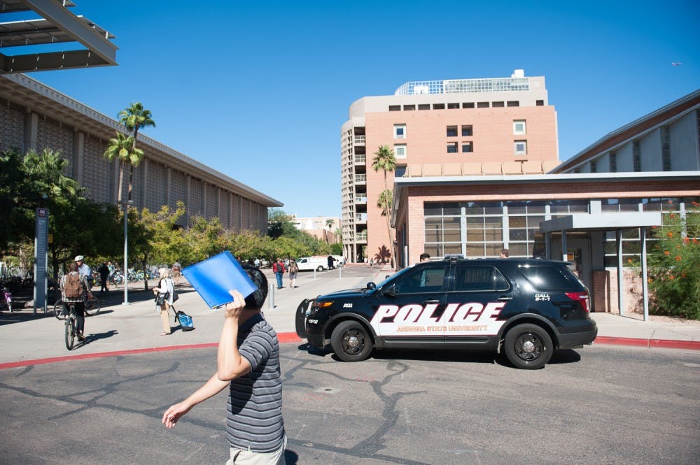 Pedestrians walk past an ASU Police cruiser on Monday, Nov. 2, 2015, on the Tempe campus. ASU Police are investigating a shooting threat made against the University last night on the anonymous internet message board 4chan.