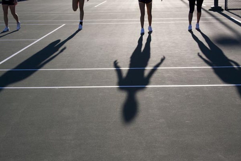 MORNING WORKOUT: Long shadows stretch across the tennis court as the ASU Tennis team warms-up for practice Thursday morning. (Photo by Annie Wechter)
