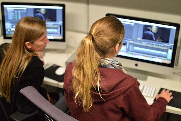 From left to right, LaDawn Haglund, an associate professor in the department of Justice and Social Inquiry who is auditing Peter Byck's class, and Annika Cline, a junior and journalism major, edit there group documentary project before their final class day ends. Peter Byck, who is a graduate of the California Institute of the Arts and director of the 2010 documentary on alternative energy "Carbon Nation," is a professor of practice at the Walter Cronkite School of Journalism and Mass Communication instructing on Sustainability Short-Form Documentary. (Photo by Corey Malecka
