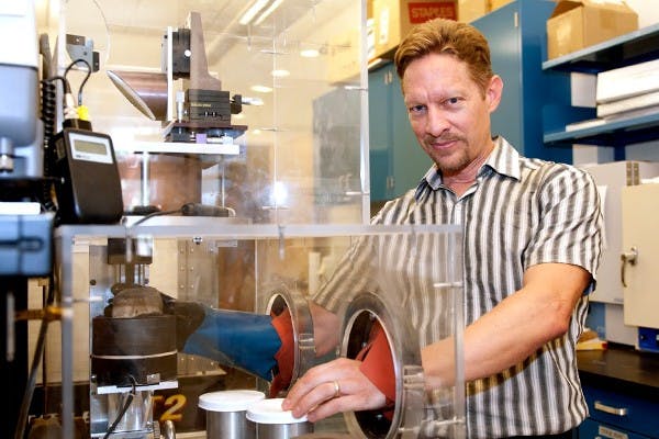 Associate research professor Steven Ruff uses an infrared spectrometer to analyze a rock sample. Ruff hopes to outfit the 2020 mars rover with a smaller infrared spectrometer to determine the presence of water and life on mars.  (Photo by Mario Mendez)