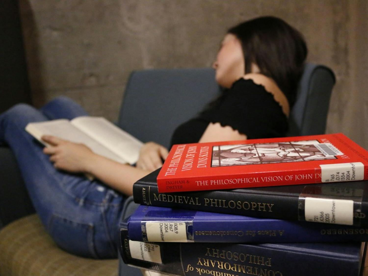 Photo illustration of a student asleep in the library on March 2, 2017. 