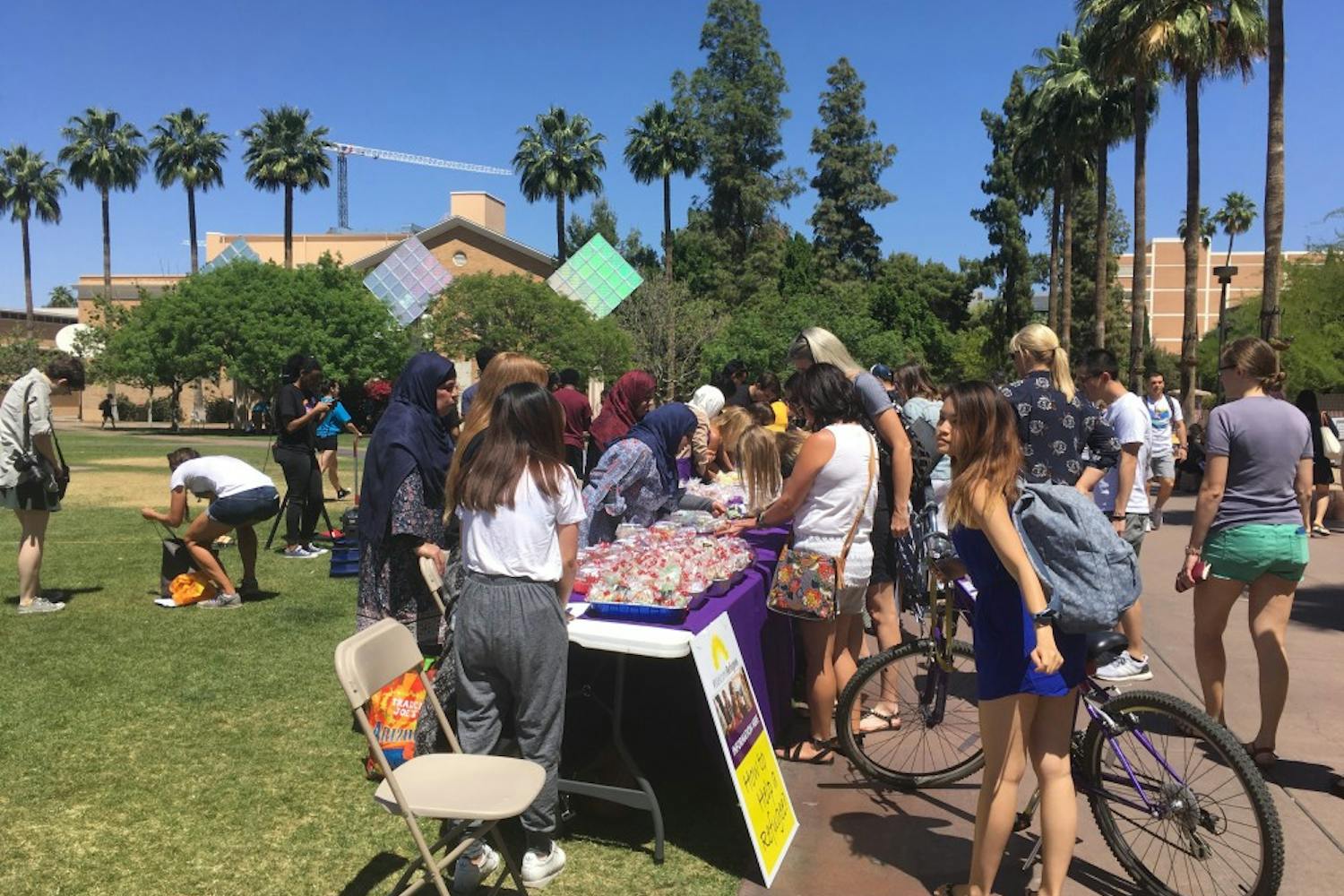 Refugees and Refugee Alliance club members sell a variety of Syrian pastries to students on the Hayden Lawn at ASU's Tempe campus on April 18, 2017 as part of their continual outreach to the refugee community. 