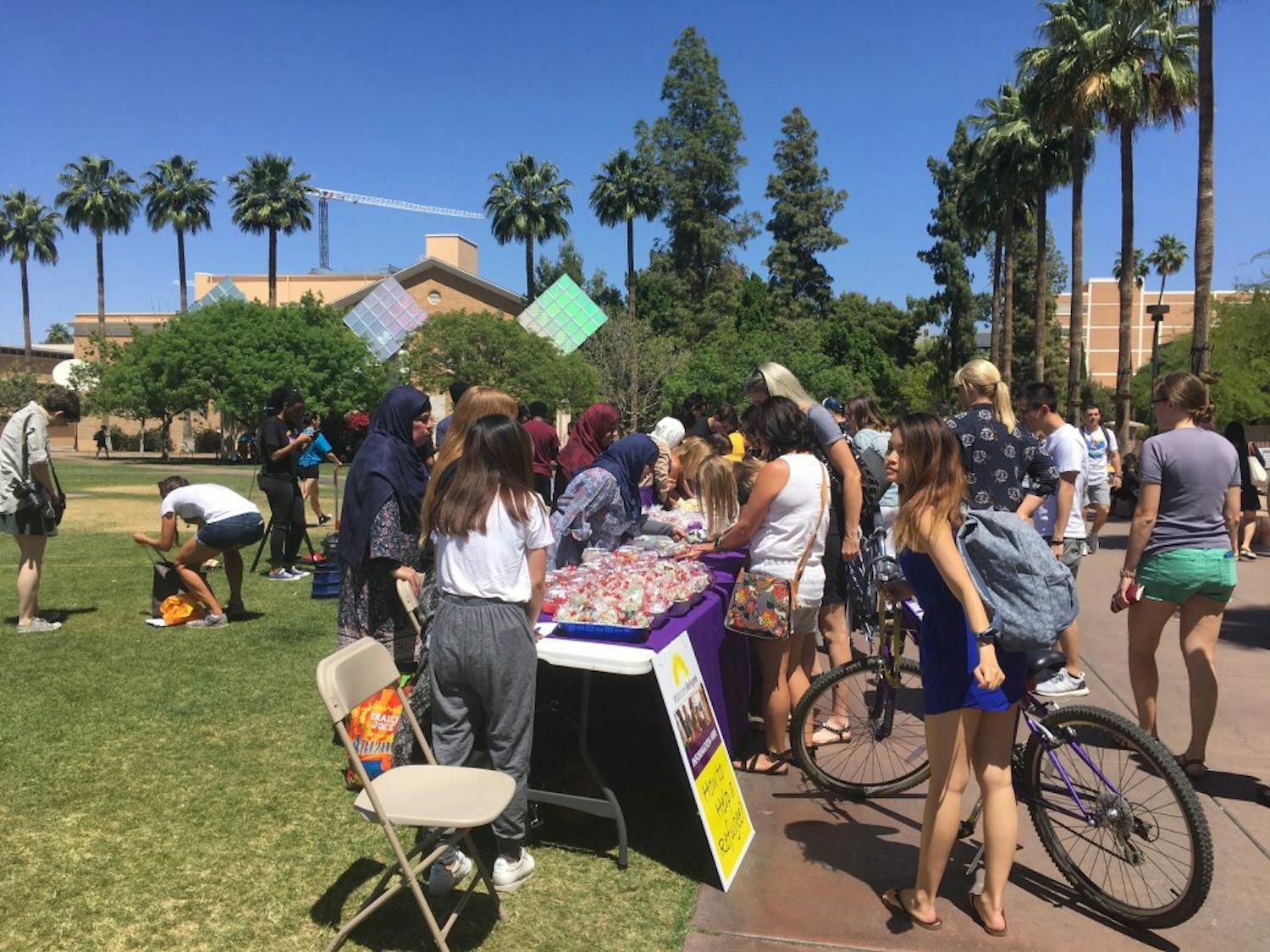 Refugees and Refugee Alliance club members sell a variety of Syrian pastries to students on the Hayden Lawn at ASU's Tempe campus&nbsp;on April 18, 2017 as part of their continual outreach to the refugee community.&nbsp;