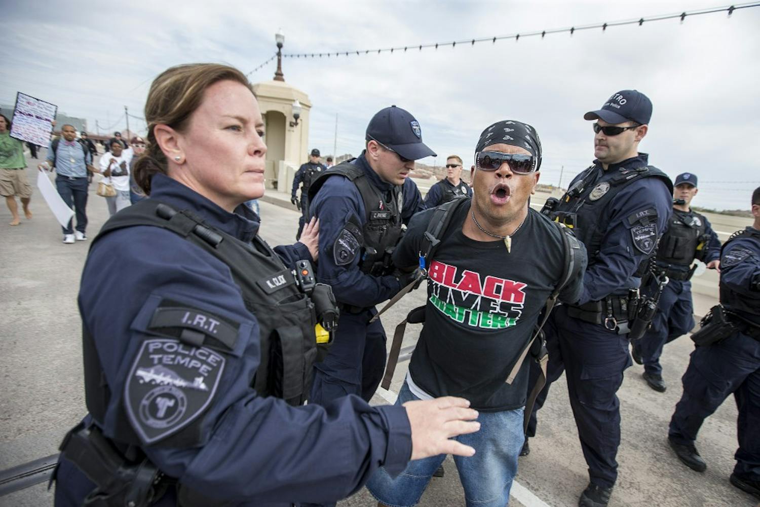 A protestor is arrested during a police-violence protest on the Mill Avenue bridge on Monday, Sept. 26, 2016.