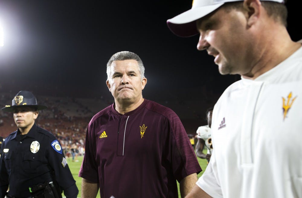 ASU Sun Devils head coach Todd Graham, center, walks off the field after a loss to the USC Trojans in the Los Angeles Memorial Coliseum on Saturday, Oct. 1, 2016. 