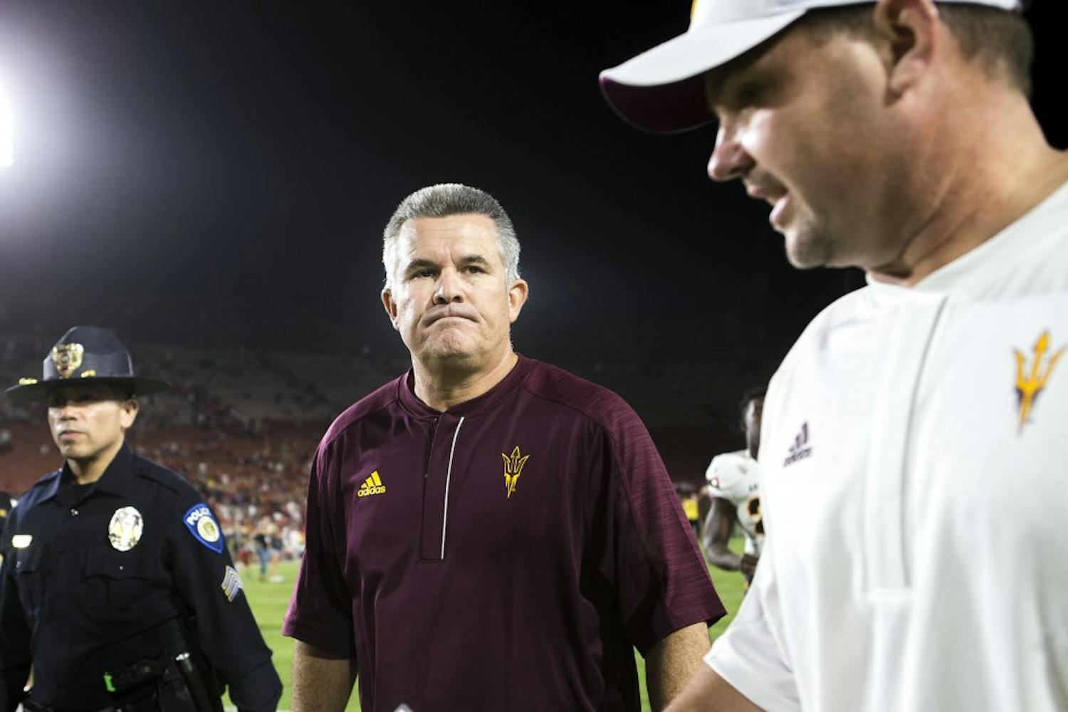 ASU Sun Devils head coach Todd Graham, center, walks off the field after a loss to the USC Trojans in the Los Angeles Memorial Coliseum on Saturday, Oct. 1, 2016. 