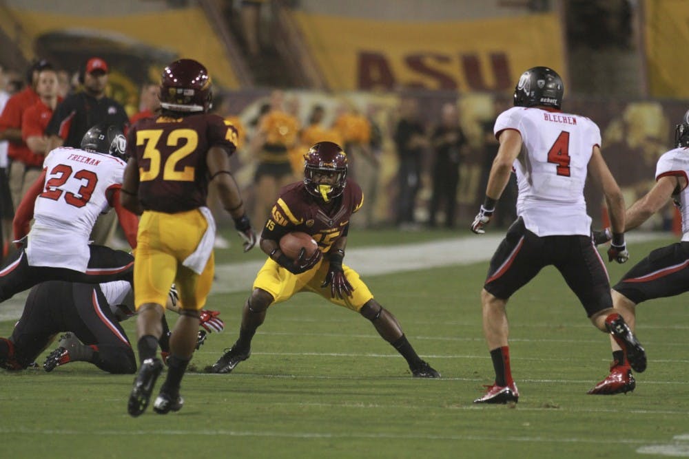 Senior wide receiver Rashad Ross tries to go around two Utah defenders during the Sun Devils’ 37-7 win over Utah last Saturday. (Photo by Sam Rosenbaum)