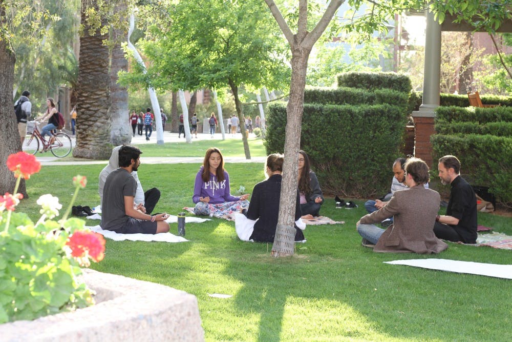 Students, staff and faculty participate in Mindful ASU's first event, an interfaith meditation at the Tempe campus on Thursday, March 23, 2017.