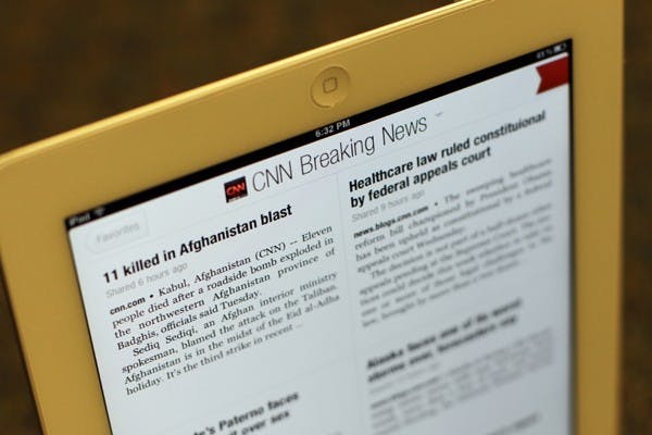 KEEPING TABS: According to a recent Pew Research Center study, the second most common use for tablets such as the iPad is news, even more than social media. (Photo by Lisa Bartoli)