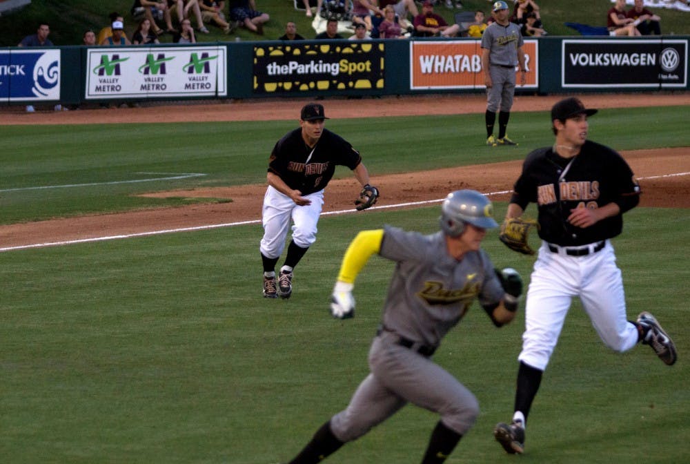 The ASU baseball team hustles to throw out a runner to first base against the University of Oregon on April 5, 2013. Oregon’s season just ended with a total of 48 wins and 16 losses. (Photo by Dominic Valente)