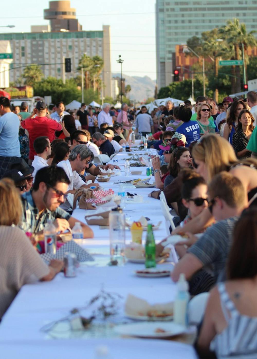 Phoenicians sit down to eat at Feast on the Street. Downtown Phoenix's feast on the street featured a mile and a half long table that stretched from Margaret T. Hance Park to ASU's downtown phoenix campus. (Photo by Dominic Valente)