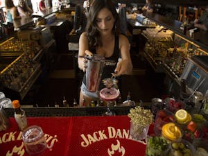 Bartender Bridget Davis, 23, makes a drink for a  customer at Whiskey Row on Thursday, April 7, 2016, on Mill Avenue in Tempe. 