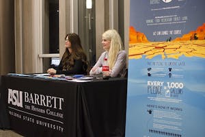 Wednesday, Nov. 12 - From left; Sam Kirk (cq) and Kathleen Carroll (cq), both Arizona State University students and employees at the Barett student engagement office, encourage students to challenge themselves in conserving more water. Their efforts are part of a larger campaign to restore 140 million gallons of water to the Colorado River Basin.