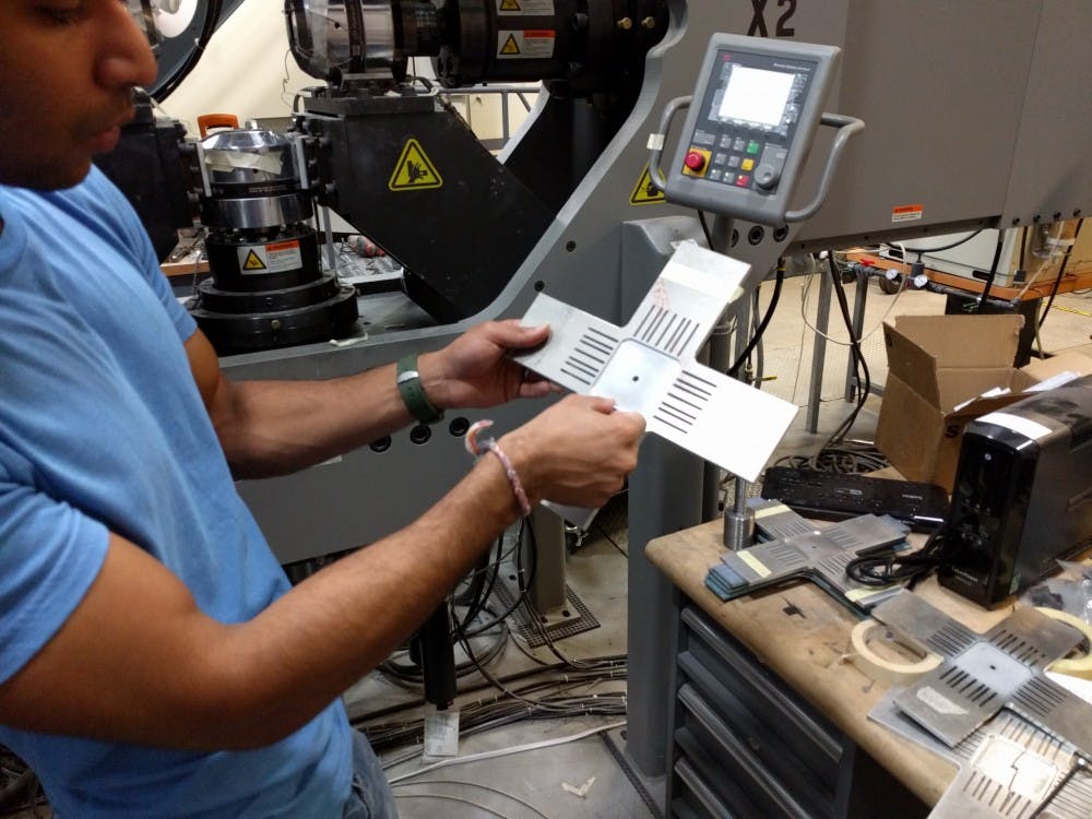 Siddhant Datta is pictured holding a metal test strip at the AIMS lab on Sept. 8, 2016.&nbsp;