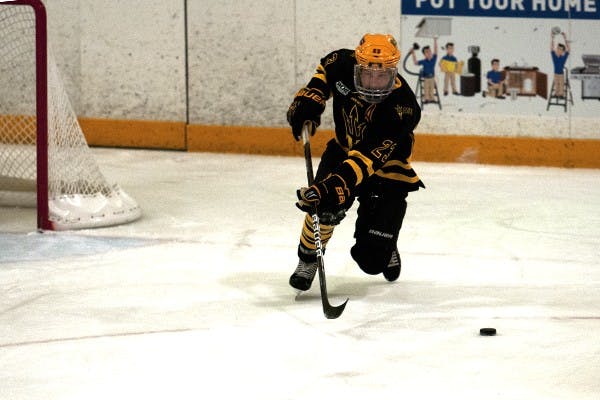 Jordan Young found himself in a scuffle at a game on Friday January 31st, leaving U of A’s player in the penalty box. (Photo by Mario Mendez)