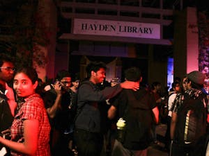 Students gather outside Hayden Library after a fire alarm went o