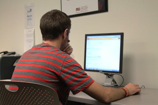 ROBIN KIYUTELLUK | THE STATE PRESS
Transborder studies sophomore Tanner Riggs ponders on which classes to choose for his 2012 spring semester. (Photo by Robin Kiyutelluk)