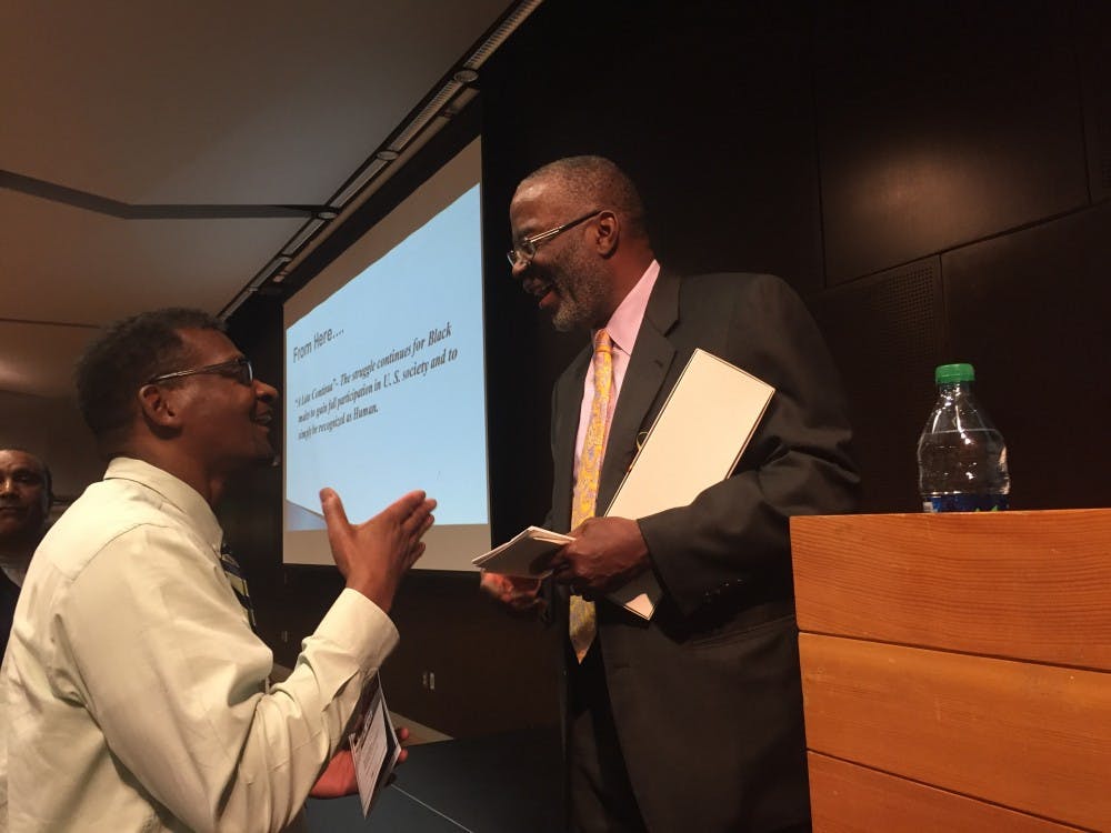 Walter R. Allen speaks with a man who attended the A. Wade Smith Memorial Lecture on Race Relations Wednesday night. The lecture discussed Allen's research on race and higher education in hopes of achieving future racial parity. (Aimee Plante/The State Press)