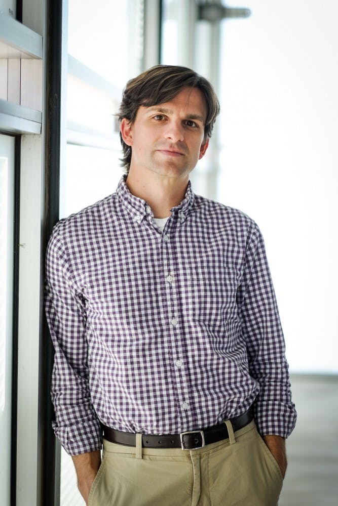 Religious studies professor Jason Bruner poses for a portrait near his office at the Tempe campus on Feb. 26, 2015. Bruner is writing a book on the East African (Balokole) Revival in Uganda. (Andrew Ybanez/The State Press)