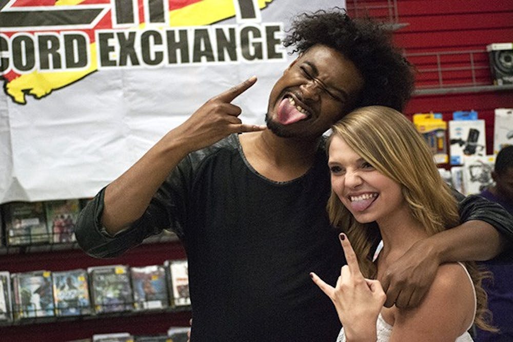  Danny Brown poses with Jelma Pejkoric at Zia Records, on November, 11, 2013. Brown made an appearance at Zia Records, signing albums and posing with fans. 