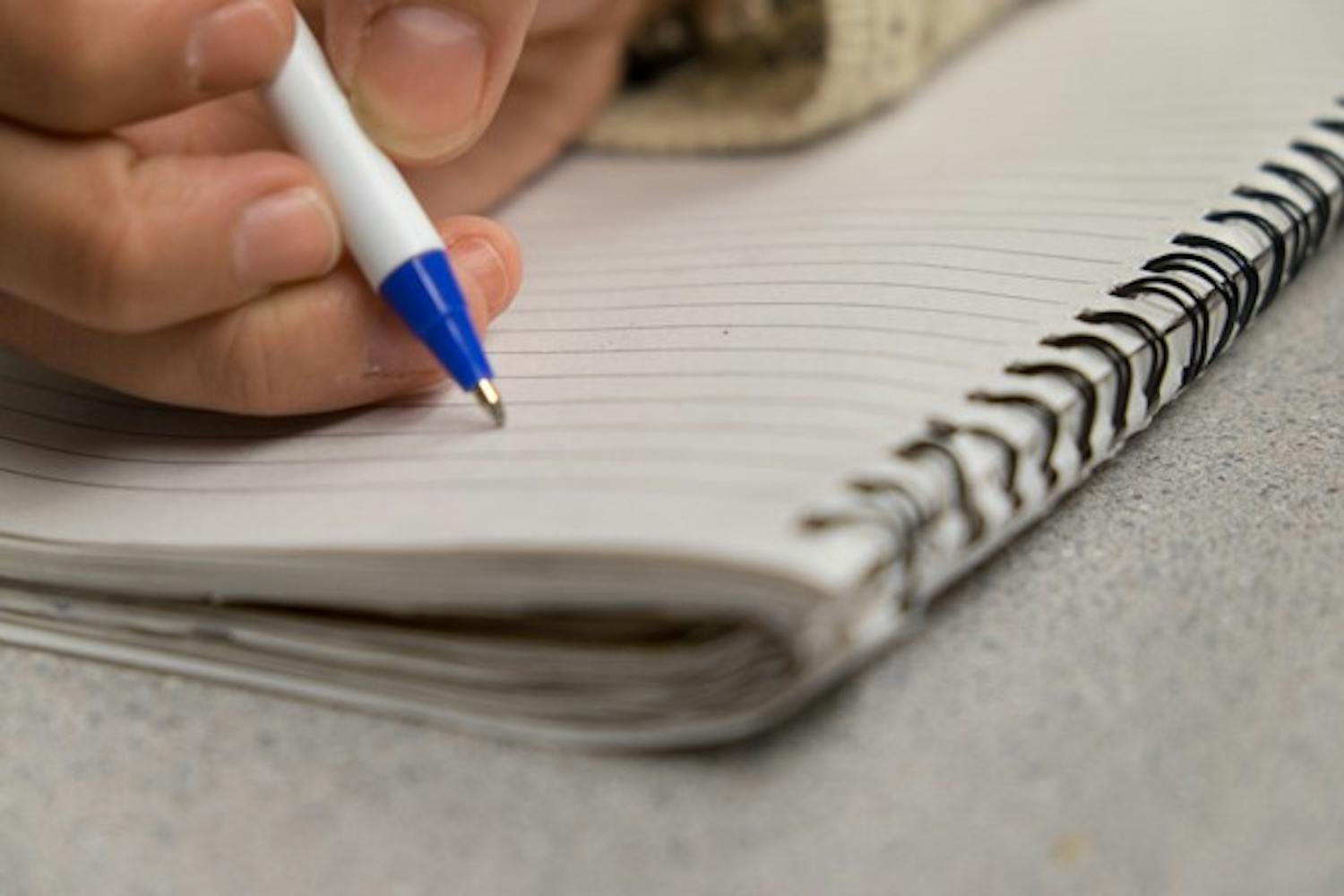 Numerous ASU professors are encouraging students to take handwritten notes in lieu of electronic notes. A study showed that students who write notes by hand do better on exams. (Photo illustration by Andrew Ybanez)