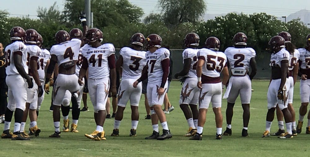 The Sun Devils including&nbsp;leaders Koron Crump (4), DJ Calhoun (3) and Christian Sam (2) getting ready to do daily calisthenics on Aug. 10, 2017.
