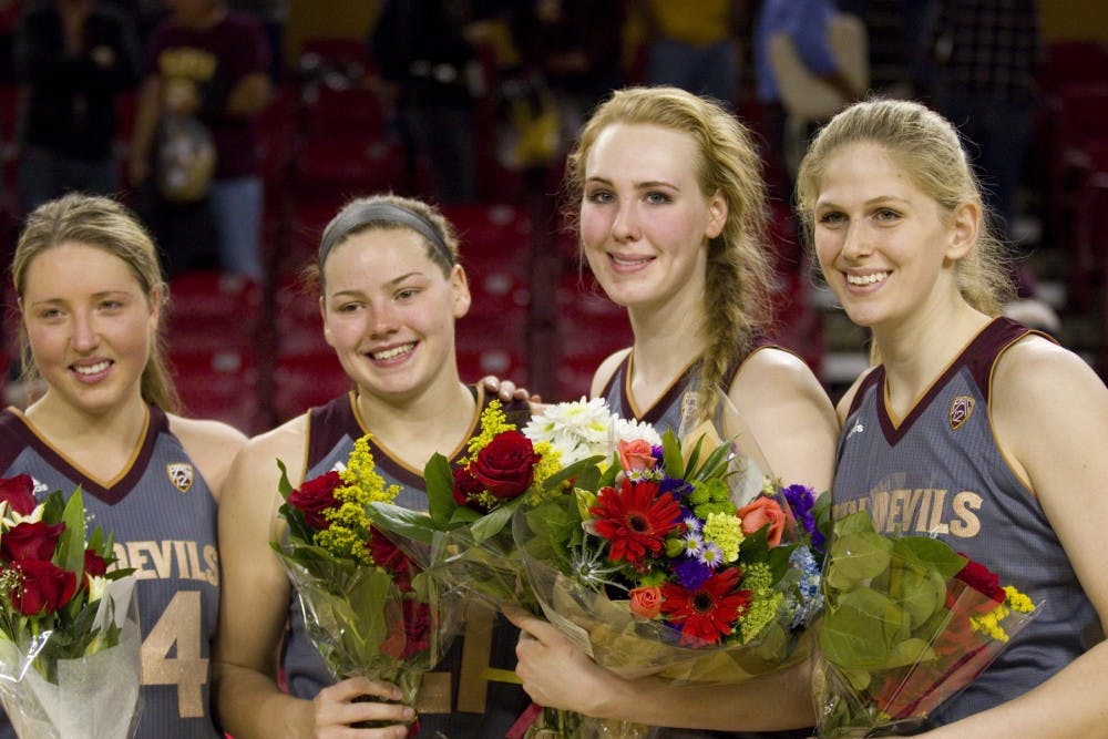 The four Sun Devil women's basketball seniors guard Kelsey Moos (24), forward Sophie Brunner (21), center Quinn Dornstauder (22), and center Sara Hattis (44) pose for a photo after a women's basketball game against the no. 15 ranked UCLA Bruins in Wells Fargo Arena in Tempe, Arizona on Sunday, Feb. 26, 2017. ASU lost 55-52.  (Josh Orcutt/State Press)