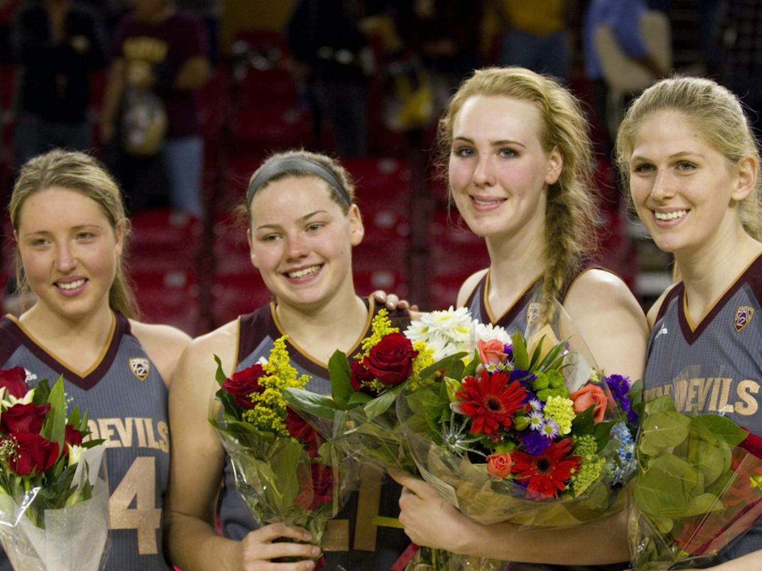 The four Sun Devil women's basketball seniors guard Kelsey Moos (24), forward Sophie Brunner (21), center Quinn Dornstauder (22), and center Sara Hattis (44) pose for a photo after a women's basketball game against the no. 15 ranked UCLA Bruins in Wells Fargo Arena in Tempe, Arizona on Sunday, Feb. 26, 2017. ASU lost 55-52.  (Josh Orcutt/State Press)