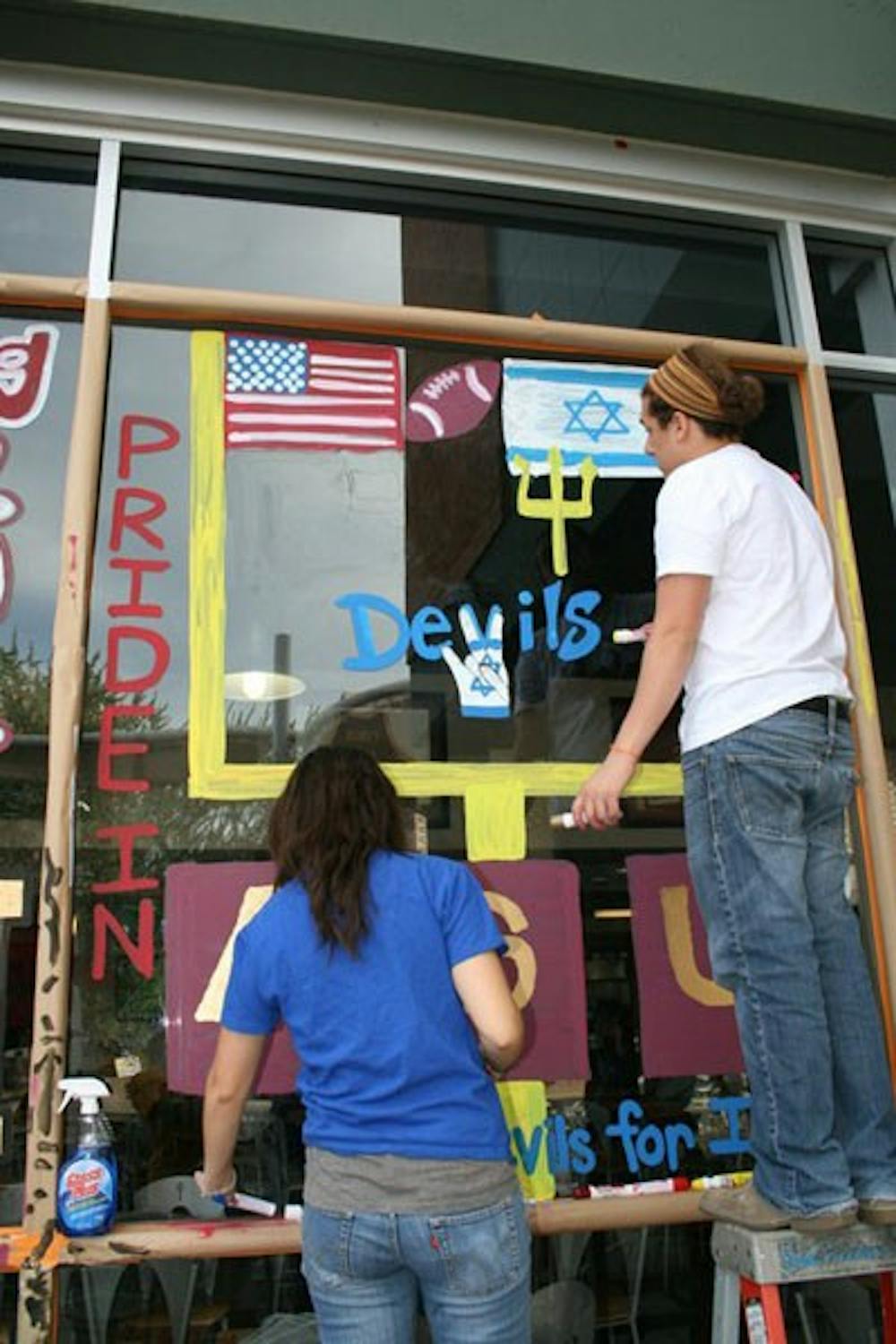 Members of Sun Devils for Israel paint a window at the Memorial Union on the Tempe campus for Homecoming 2011. (Photo courtesy of Melissa Rauch)