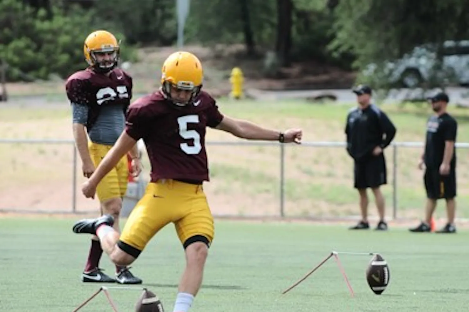 Sophomore place kicker Zane Gonzalez kicks a football during a warm-up at Camp Tontozona 2014. Gonzalez started as a freshmen last season. (Photo by Andrew Ybanez)