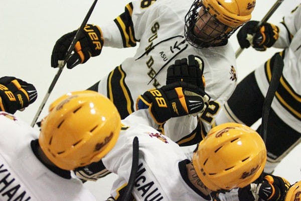 Junior forward Troy Scott gives high fives down the line after one of ASU’s 13 goals against Texas A&M. Scott tacked on one goal in the Sun Devils 13-0 victory on Sept. 20. (Photo by Kyle Newman)