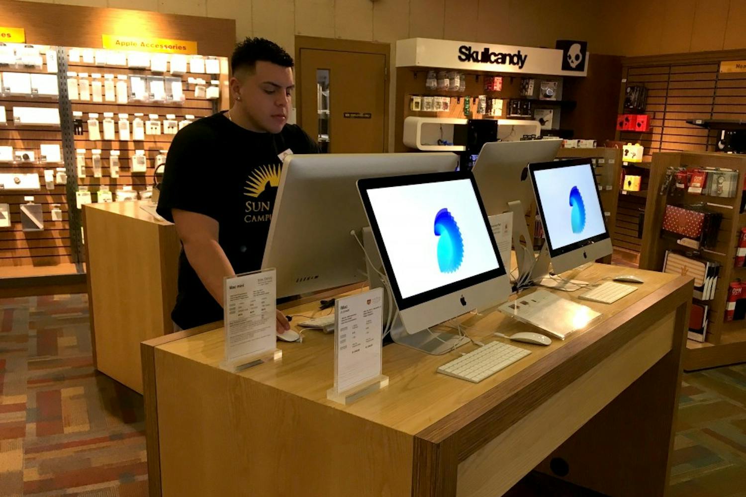 Joey Martinez checks out new Apple computers at the ASU bookstore in Tempe, Arizona on Sunday, Feb. 5, 2017.