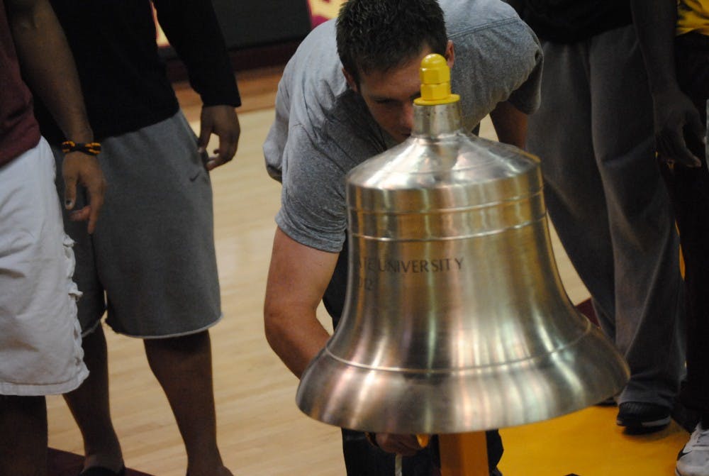 ASU quarterback Taylor Kelly rings the Victory Bell to signify the Territorial Cup win over U of A. Photo by Nick Krueger
