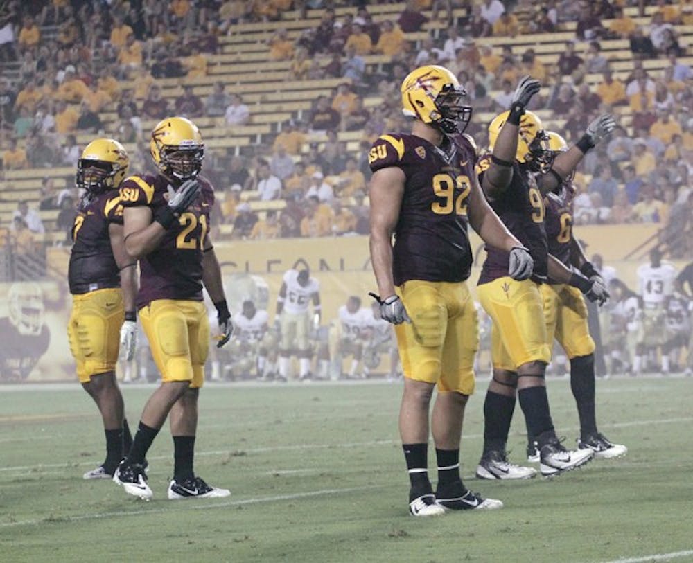 UNDER THE RADAR: ASU redshirt senior linebacker Colin Parker (21) looks to the sideline during the Sun Devils’ victory over UC Davis on Sept. 1. Parker has been the unsung leader of the ASU defense all season. (Photo by Beth Easterbrook)